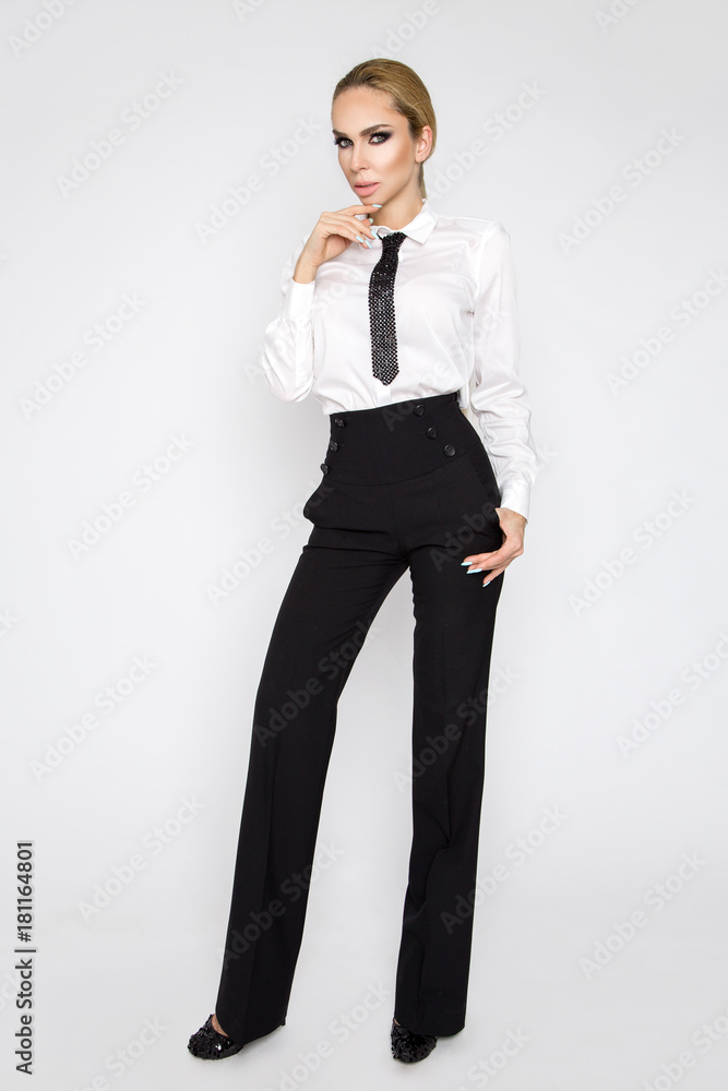 Beautiful elegant sexy blonde female model dressed in white