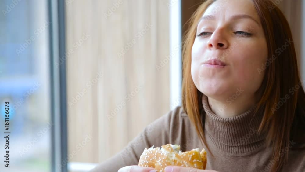 Young woman eating fast food, hamburger and french fries Young woman eating fast food, hamburger and french fries