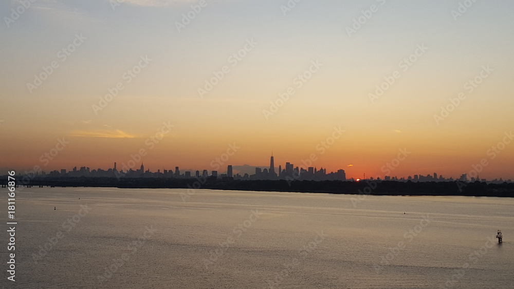 Sun rising on Manhattan skyline in newyork view from cargoship