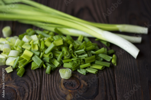 chopped onions and green onions on a wooden table photo