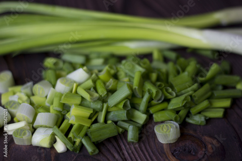 chopped onions and green onions on a wooden table photo