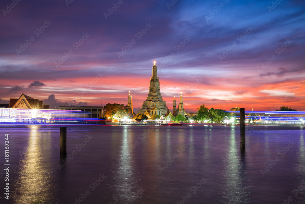 Wat Arun Temple during sunset with dramatic sky in Bangkok, Thailand