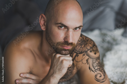 Close-up portrait of a bald brutal man with a beard 15.