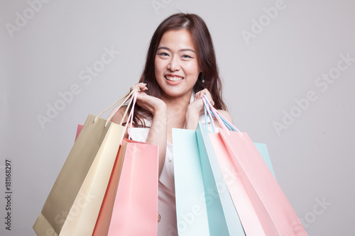 Beautiful young Asian woman with shopping bags.