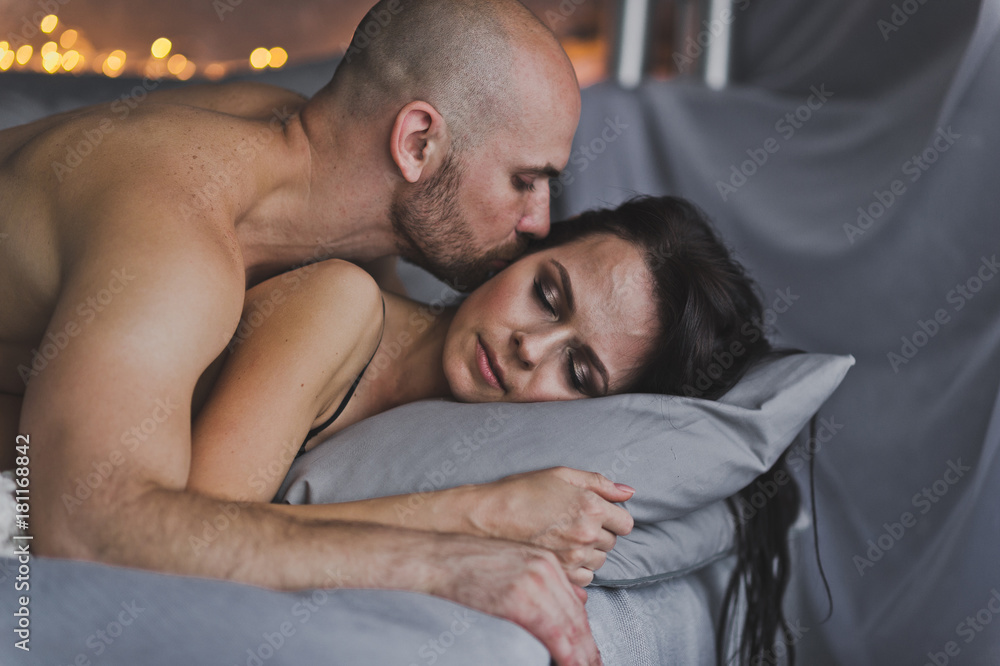 Fototapeta premium Young man kissing the cheek of a sleeping girl 260.