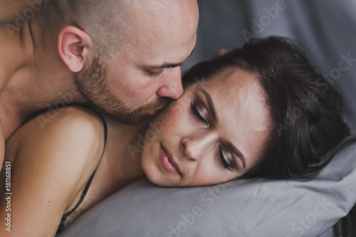 Young man kissing the cheek of a sleeping girl 261. © alenazamotaeva
