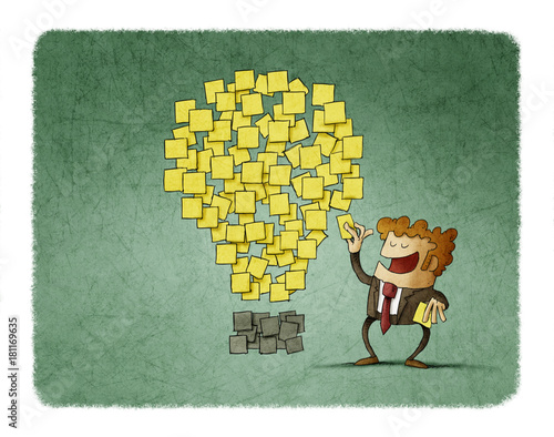 businessman sticks a post note next to others that are shaped like an idea. c...