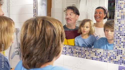 Happy family dancing and singing in front of mirror in bathroom