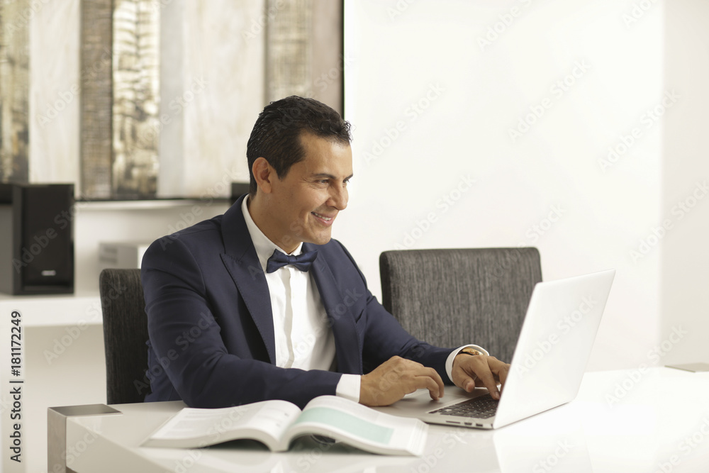 elegant executive man posing to the camera and using technology elegant executive man posing to the camera and using technology