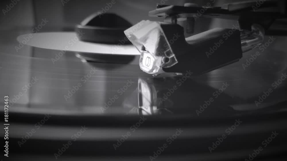 Close-up of using an antiquarian vinyl record player. Man relaxing while listening to music in his free time. Record player retro turntable that plays vinyl vintage records Close-up of using an antiquarian vinyl record player. Man relaxing while listening to music in his free time. Record player retro turntable that plays vinyl vintage records