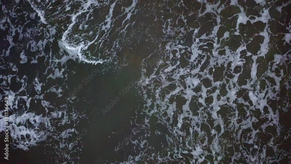 Aerial view of waves crashing into each other on the beach. Aerial view of waves crashing into each other on the beach.
