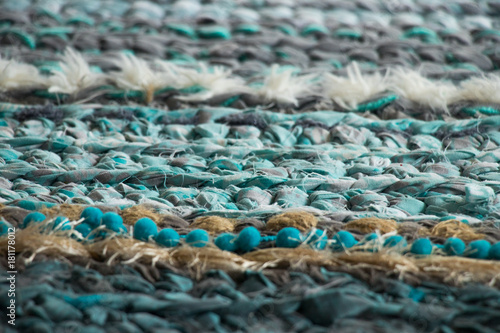 colorful turquoise handmade woven rug close up consisting of various textures © Magdalena