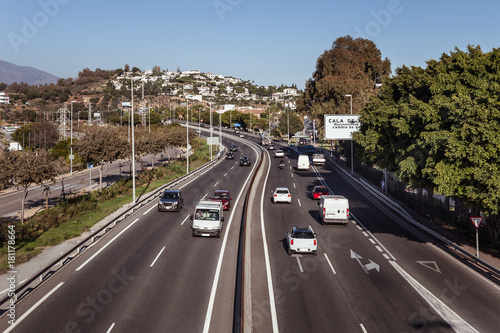 Highway asphalt two way road with cars and trucks. Tropics