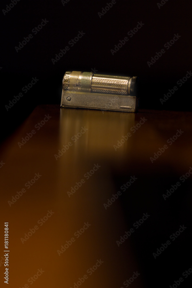 Old metal lighter on dark background. Old metal lighter on dark background.