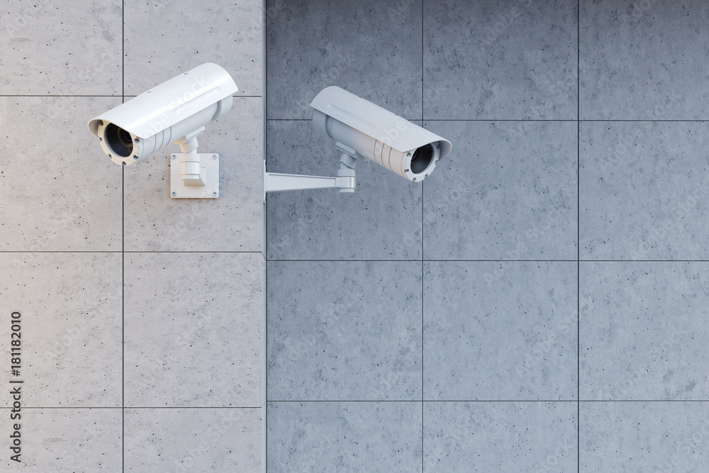 White cameras on a gray wall White cameras on a gray wall