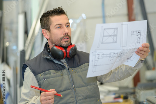 Tableau sur toile architect builder studying layout plan of the rooms
