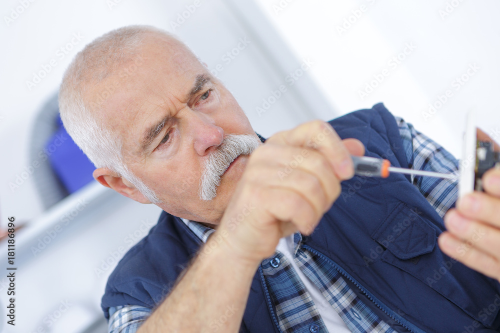 senior adult electrician checking and repairing plug senior adult electrician checking and repairing plug