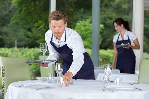 male waiter setting wedding table photo