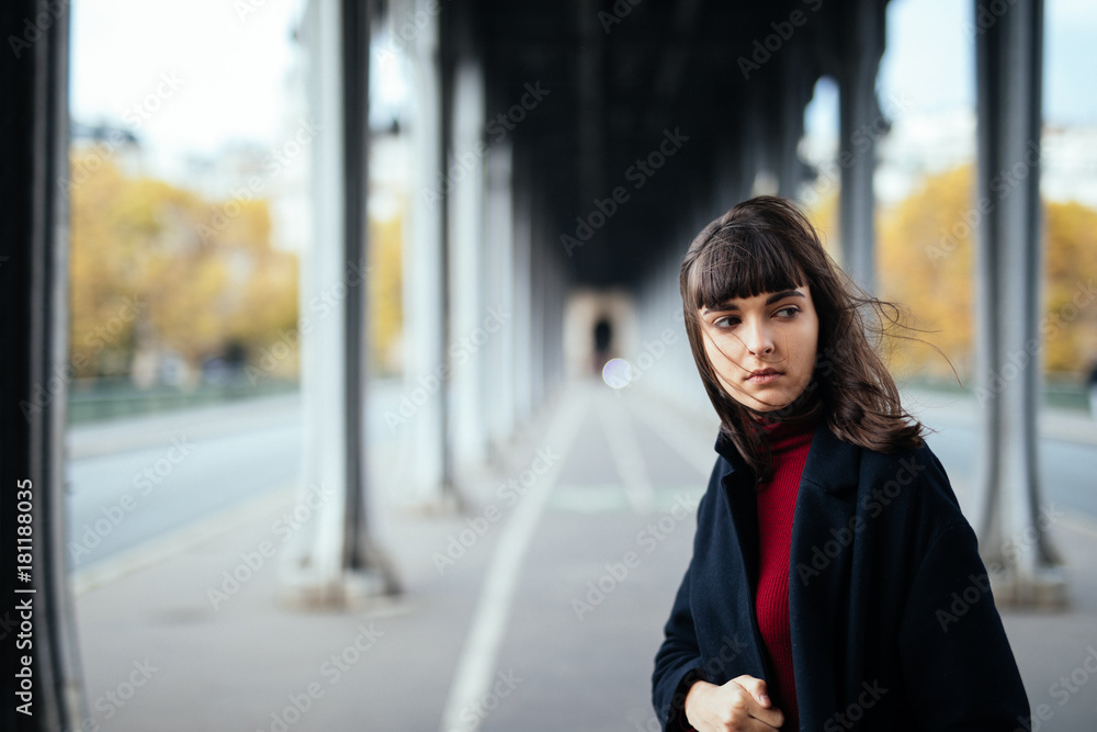 Closeup portrait of effective girl look to camera on street background.