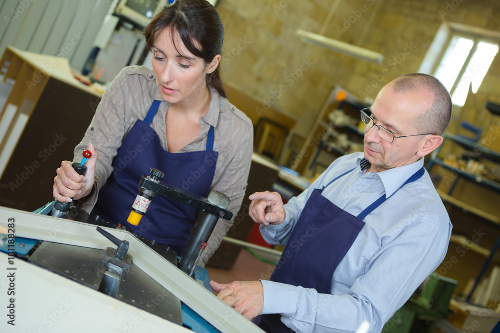 Obraz premium male and female colleagues checking structure in factory