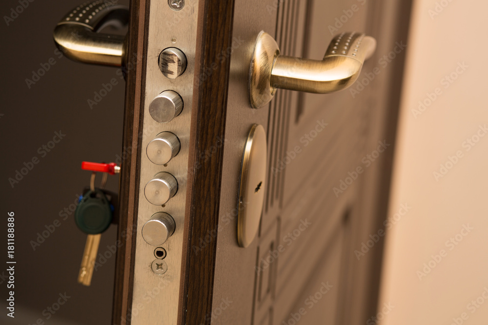 Obraz premium Closeup shot of modern door lock with a key. Empty space