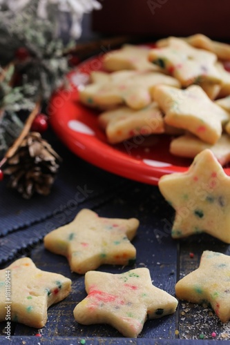 Christmas star shaped sugar cookies on festive xmas background
