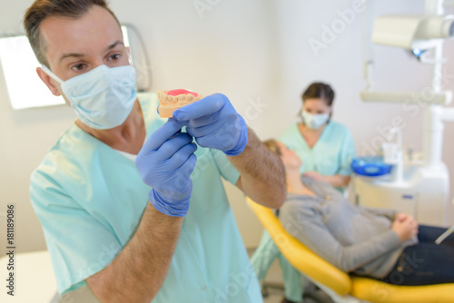 Dentist preparing prosthetics for patient