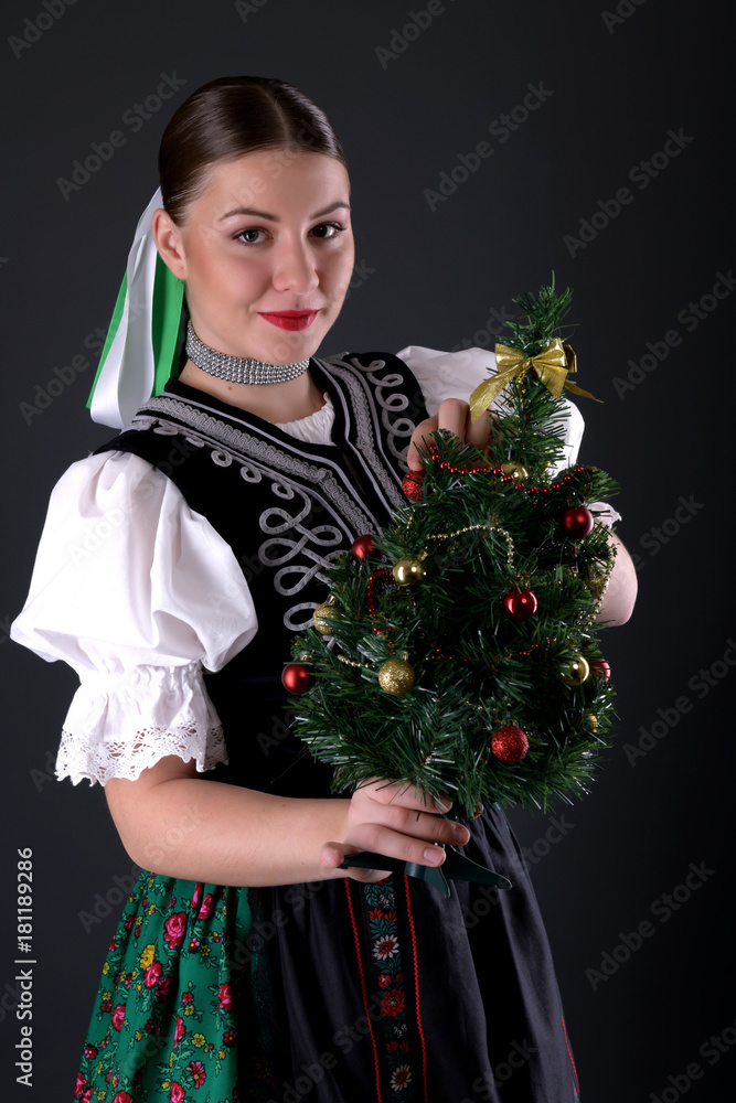 girl in traditional clothes with christmas tree girl in traditional clothes with christmas tree