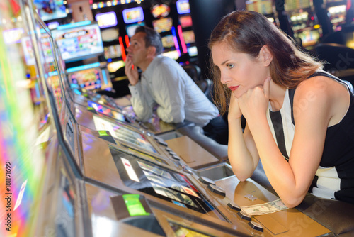 Woman losing on machine in casino