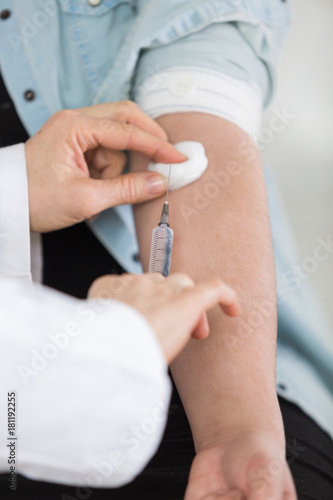 doctor injecting diabetic patient