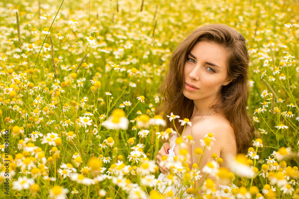 Photo of pretty brunette woman in chamomile field Photo of pretty brunette woman in chamomile field
