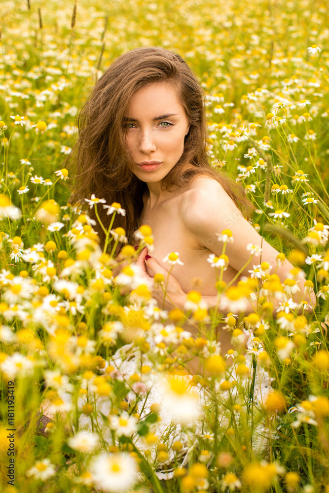 Sexy brunette young woman in chamomile field Sexy brunette young woman in chamomile field