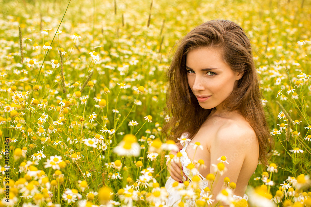 Sexy brunette young woman in chamomile field Sexy brunette young woman in chamomile field