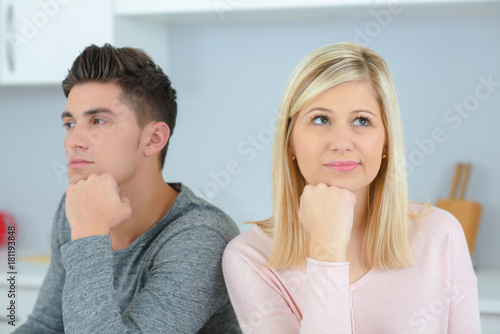 man and woman with their chins on their hands