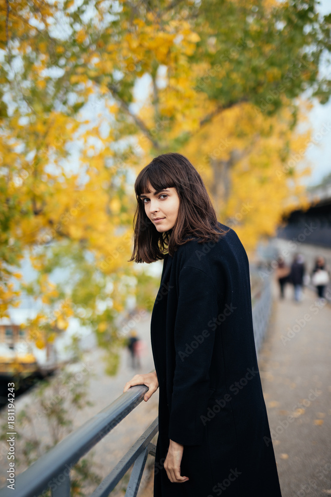 Outdoor fashion portrait of glamour sensual young stylish lady wearing trendy fall outfit , black coat on Cold season on Paris streets Outdoor fashion portrait of glamour sensual young stylish lady wearing trendy fall outfit , black coat on Cold season on Paris streets