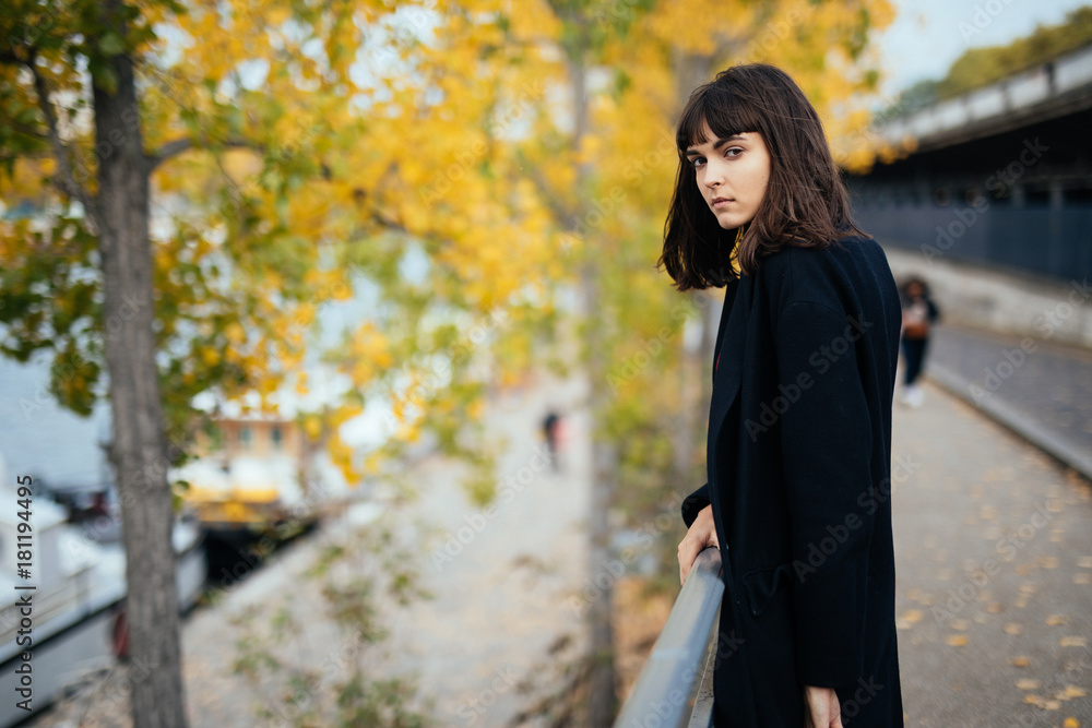 Outdoor fashion portrait of glamour sensual young stylish lady wearing trendy fall outfit , black coat on Cold season on Paris streets Outdoor fashion portrait of glamour sensual young stylish lady wearing trendy fall outfit , black coat on Cold season on Paris streets