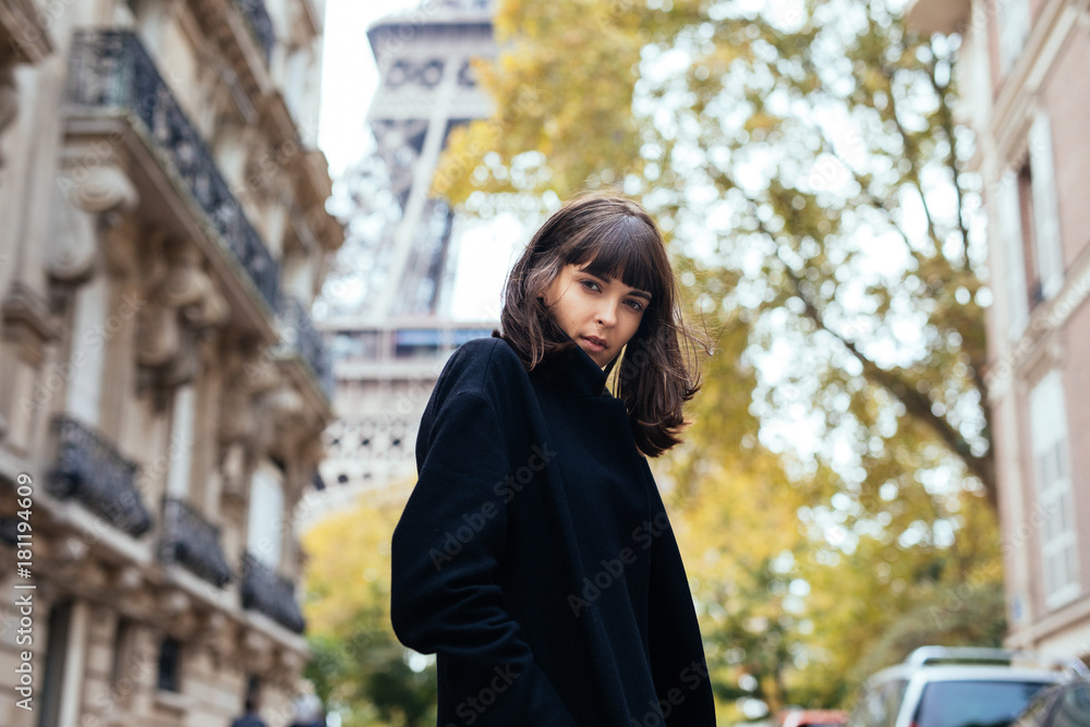 Outdoor fashion portrait of glamour sensual young stylish lady wearing trendy fall outfit , black coat on Cold season on Paris streets