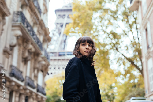 Canvas Print Closeup portrait of effective girl smiling to camera on Paris street on with Eiffel background