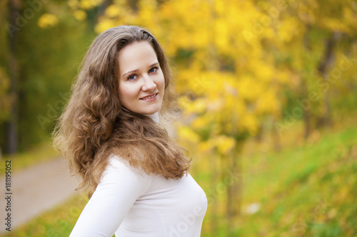 Young beautiful woman in autumn park