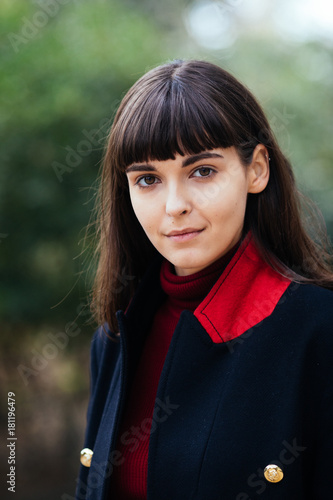 young beautiful brunette woman portrait with short hairs in coat on the Paris streets