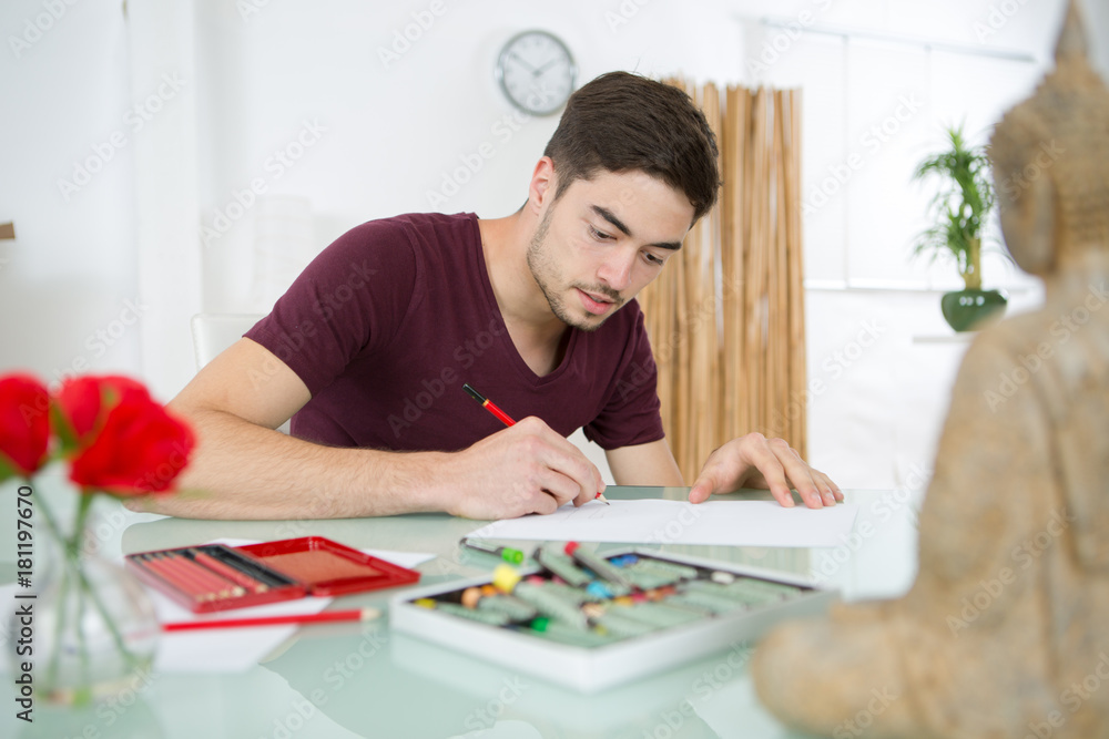 creative young man drawing at home creative young man drawing at home