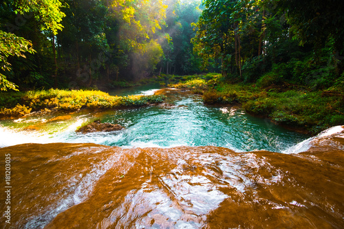 Fototapeta Naklejka Na Ścianę i Meble -  Than sawan Waterfall, Payao, Thailand, Normal shot, Beautiful green waterfall in the nature at sunset..