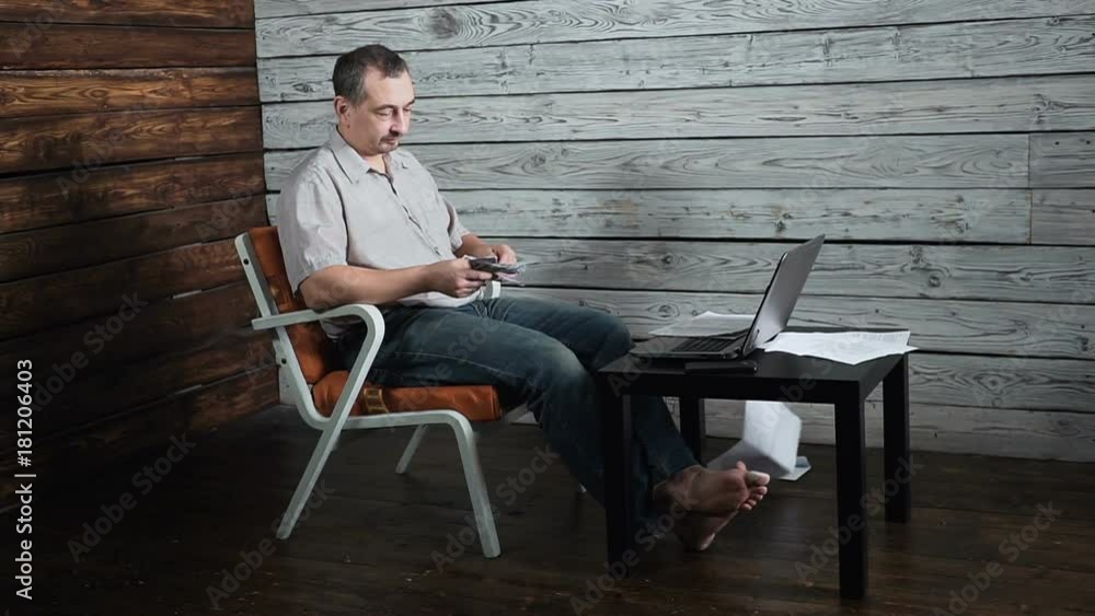 50 years old man with laptop receiving negative news, upset and surprised 50 years old man with laptop receiving negative news, upset and surprised