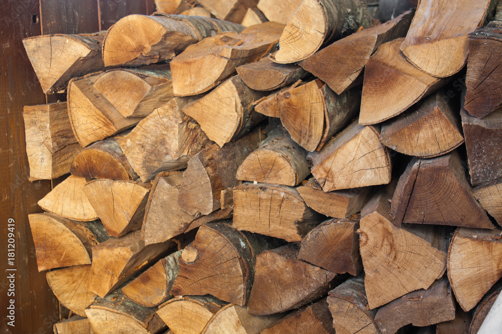 Woodpile of chopped lumber. Pile of wood logs. Stacked firewood timber Woodpile of chopped lumber. Pile of wood logs. Stacked firewood timber