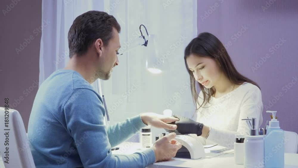 Master makes manicure to the man Master makes manicure to the man
