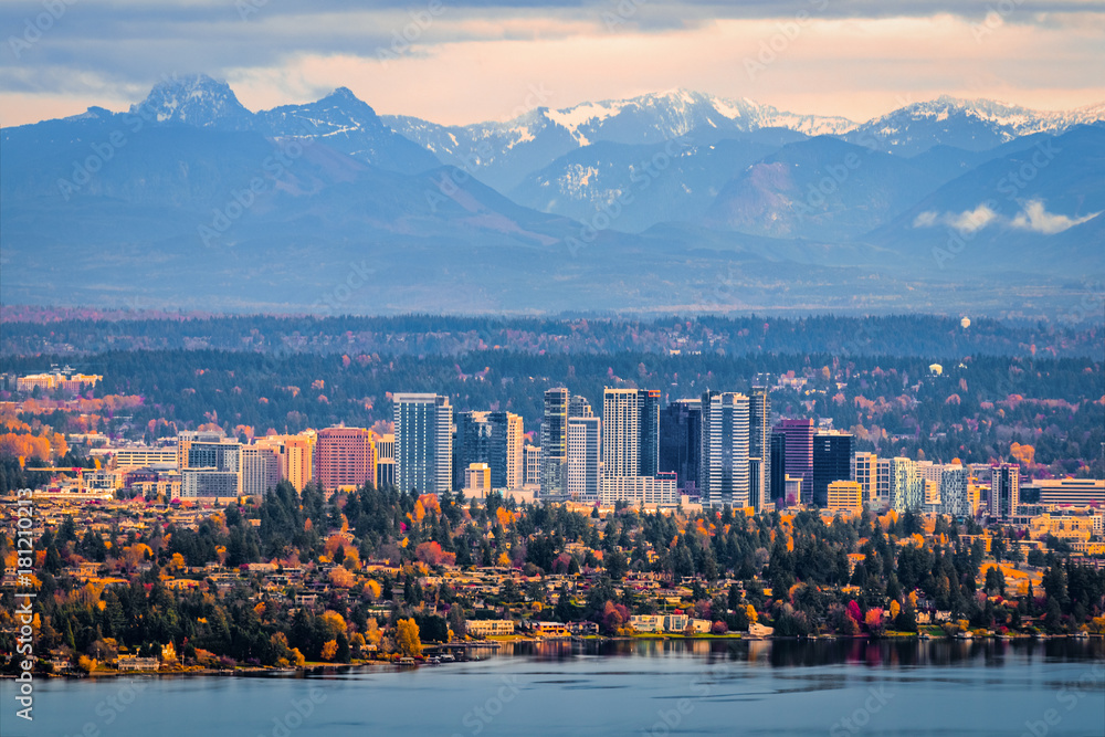 Bellevue Washington. The snowy Alpine Lakes Wilderness mountain peaks rise behind the urban skyline.