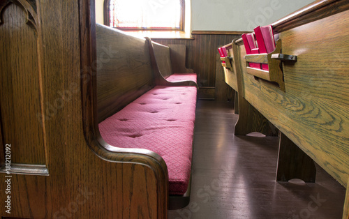 Empty Church Pew. Interior of an empty church with pew and row of bibles.