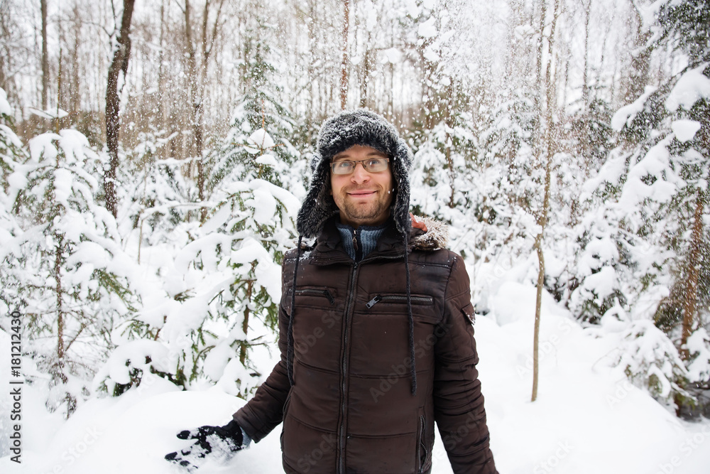 Man in fur winter hat with ear flaps smiling portrait Man in fur winter hat with ear flaps smiling portrait