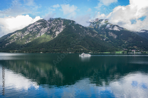 Beautiful landscape Achensee lake  alpine mountains  blue sky and clouds  reflections in water. Tirol  Austria.
