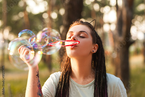 Woman bubble blowing hiker nature concept. Unity with the nature. Traveler leisure.